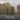 Sandcastle being built with a pink mould in a sandy area, featuring the 'Sandcastle Certified' logo.