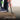 Person using crowbar as a leverage force multiplier tool on a wooden pallet with a blurred background