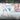 Ruler with text 'High Accuracy' and 'Precise Markings' on a blurred background of hands writing.