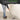 Person using a soft bristle broom on a hard surface floor with text about durability and efficiency.