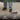 Person cleaning a surface with a broom, text 'Built for Every Space' above, with icons and text about cleaning tools and caravans/RVs.