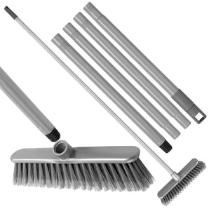 A grey broom dismantled into 5 pieces, 4 handle sections and the head. The head and one piece are threaded for screwing together. White background.