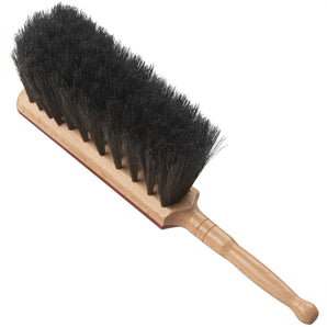 Wooden hand brush with black bristles on a white background
