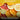 Sliced citrus fruits with a text overlay describing the worm cast enhanced compost containing 100% organic fertiliser.