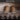 Two wood logs in an open wood burner, text 'Clean Burning' and icons indicating features like less sparking, minimal dust, chemical free, and low ash.