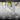 Metal tool with text 'Easy to Handle' on a blurred background of tools and equipment.