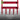 Close in shot of 5 red metal tines with green leaf logo on a grey background