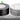Two rolls of tape, one black and one silver, on a white background with a green leaf logo.