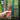 Hand zipping up the front of a greenhouse screen with text reading 'Simply Practical' and features listed.