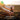 Hands holding soil with a sunset background and text about enhancing soil health.