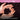 Hands holding soil with a pink top and black bottom, featuring text about John Innes formulated feed.