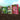 Hardys compost products on a soil background with a garden scene.